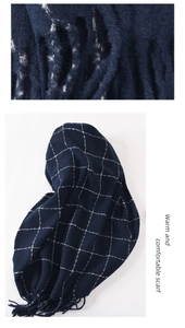 Macro detail of navy blue plaid scarf texture with soft fringes and warm fabric