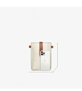 Detailed view of cream and brown leather phone bag showing dimensions 17.5 x 12.5 x 4.5 cm