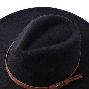 Detailed close-up view of a black wool felt fedora hat with a brown leather strap