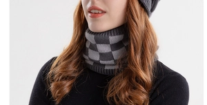 Detail of grey checkered knit neck warmer showing soft texture and cozy winter pattern
