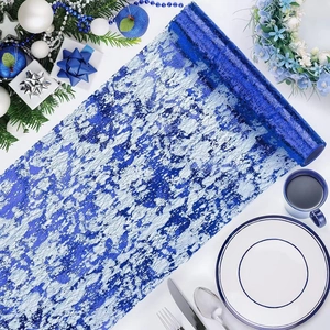Blue and silver abstract pattern mesh table runner roll with festive holiday decorations