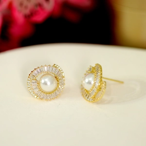 Macro shot of a luxury halo pearl stud earring with baguette-cut zircon detailing