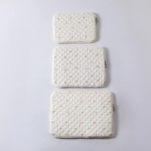 Detailed set of three floral quilted cotton sleeves for laptop and tablet in cream white
