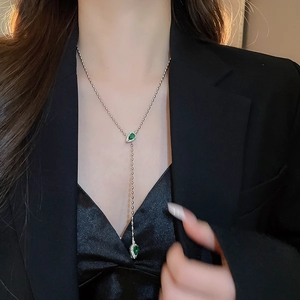 Elegant silver snake Y-necklace with emerald-green gems and sparkling zircon stones