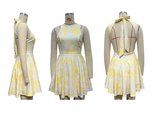 Detailed back view of a floral summer dress featuring an open back and large bow tie accent