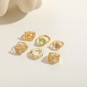 Detailed view of six 14K gold plated rings with colorful zircons and flower designs