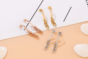 Detailed shot of long chain dangle earrings in rose gold, gold and silver finishes