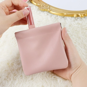 Pink PU leather lipstick pouch with automatic closure shown on white plush background