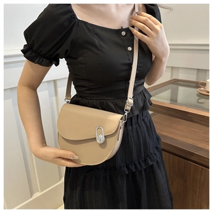 Minimalist beige PU leather saddle bag for women featuring a smooth finish and silver hardware