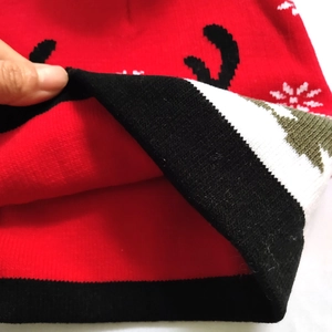 Detail shot of the red knitted Christmas hat showing double-layer thickness and lining