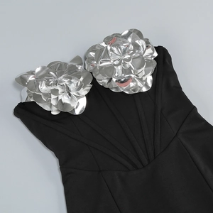 Detailed view of silver 3D floral accents on a slim fit black strapless evening gown
