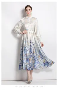Detailed view of satin floral dress with lantern sleeves and gradient flower print