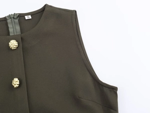Detail of dark army green sleeveless midi dress with gold crest buttons and metal zipper