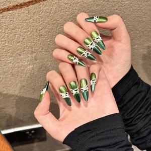 Metallic green stiletto press-on nails with hand-painted snake pattern and cat-eye finish