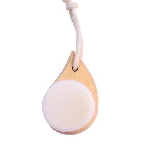 Detail of wooden facial brush with soft white bristles and convenient cotton hanging rope