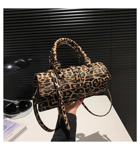 Detail shot of leopard print pu leather crossbody bag with dual handles and long strap