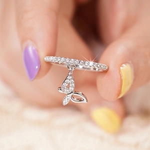 Close-up of butterfly pendant ring with shimmering zircon stones in silver finish