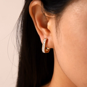 U-shaped gold stainless steel earrings with rectangular zircon stones on model