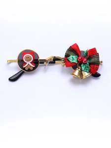 Close-up of Christmas sunglasses with gold metal frame, festive bear, and plaid bow