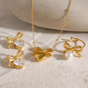 Golden 18k stainless steel jewelry set featuring bowknot heart pendants and zircons