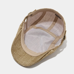Close-up of the khaki cotton linen flat cap showing breathable white mesh lining detail