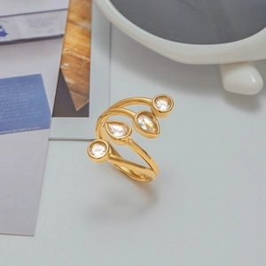 Detail view of gold layered ring with teardrop and round cubic zirconia stones