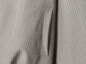 Close-up detail of grey pinstripe fabric and high-quality pocket sewing craftsmanship