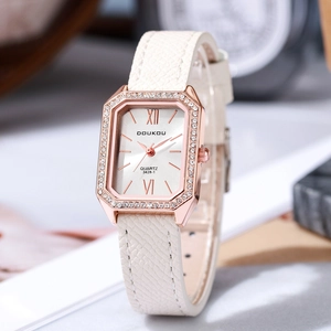 Detail of rectangular rose gold watch with crystal bezel and white leather strap