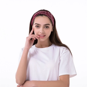 Women's paisley print cross headband in dark red shown on a model for sport and casual wear