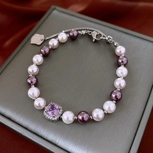 Detail showing vintage pearl bracelet with square purple gemstone and silver chain