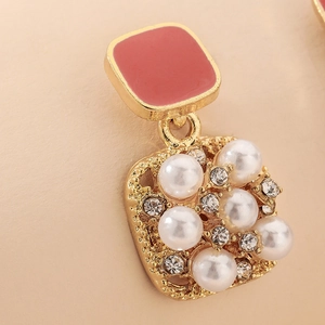 Detail of pink enamel square stud with white imitation pearls and tiny rhinestones