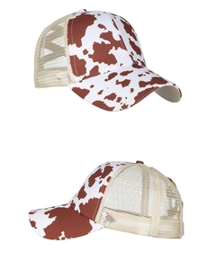 Detail view of cow print baseball cap featuring breathable mesh back and curved brim