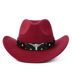 Detailed view of burgundy felt cowboy hat with leather band and silver bull head icon