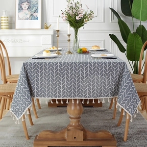Detail shot of grey herringbone linen tablecloth with delicate fringe tassels edge
