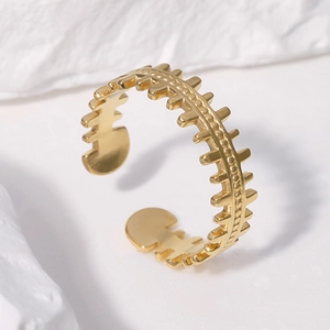 Polished gold plated stainless steel open ring with fishbone hollow design on white stone