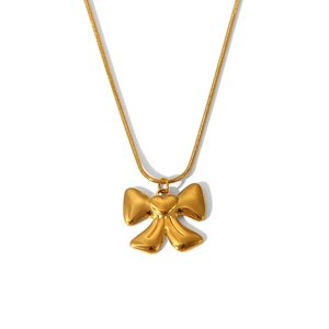 Detailed close-up of a gold butterfly bow pendant with a heart on a thin snake chain