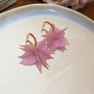 Detailed macro view of pink acrylic petal C-shaped earrings with elegant gold metal finish
