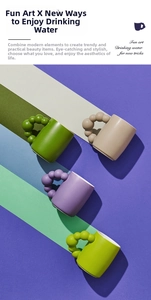 Artistic ceramic mugs with unique bubble handles in pastel colors and modern design