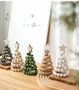 Detail of five Nordic wooden beaded Christmas trees and rustic jute twine miniature trees