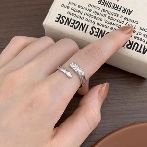 Detail of minimalist 925 silver irregular ring with diamonds on model hand