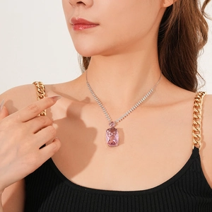 Detailed view of square pink crystal pendant on sparkling silver-tone tennis chain