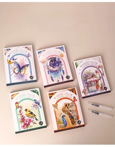 Detail view of five watercolor painting books with dried paint palettes and water brushes