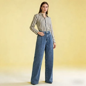 Full view of high waist wide leg denim trousers paired with a striped long sleeve shirt