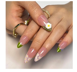Detail of almond-shaped nails with green French tips, 3D daisies and small rhinestones
