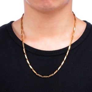 Model wearing a gold stainless steel bar link chain necklace against a black t-shirt