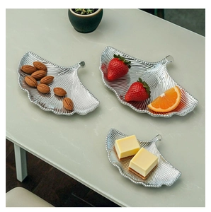 Detailed close-up of ginkgo leaf metal trays showing elegant silver textures and vein patterns