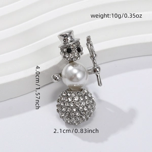 Detail view of snowman brooch with rhinestones, pearl, and size dimensions 4x2.1cm