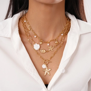 Three-layer beach necklace set featuring gold shells, starfish and white pearls for women