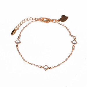 Detail of gold butterfly bracelet featuring white cubic zirconia and heart charm