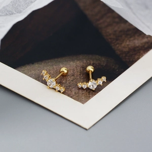 Close-up of gold s925 silver curved bar earrings with rows of sparkling zircon stones